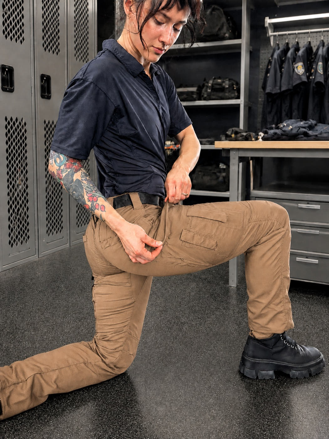 Woman moving in tan MGT tactical pants, showing the fit and cargo pockets