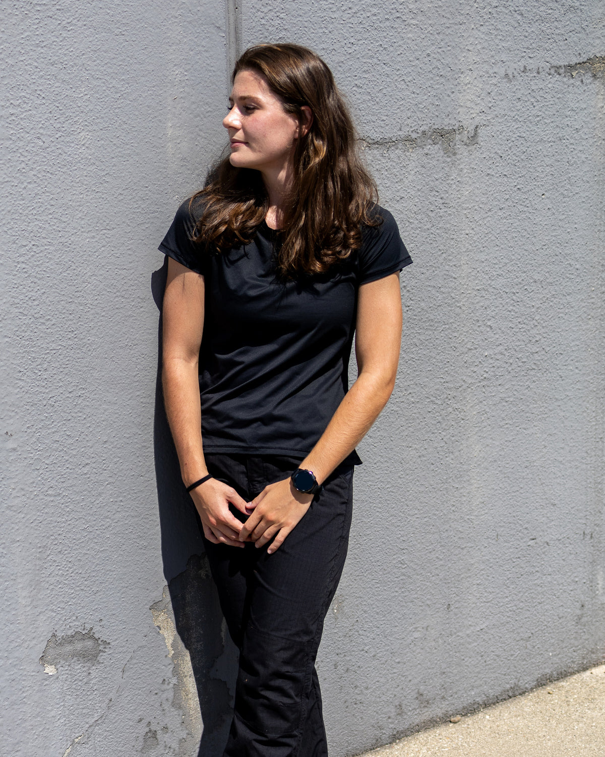 Woman wearing the black MGT Gear crew-neck performance tee