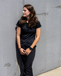 Woman wearing the black MGT Gear crew-neck performance tee