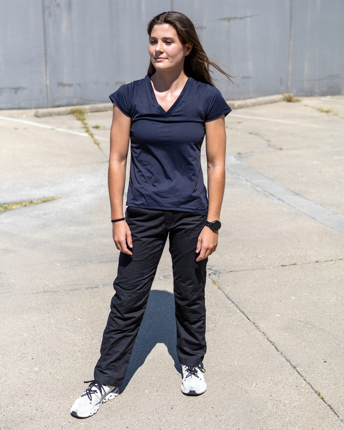 Woman wearing MGT Workwear pants, full-length view